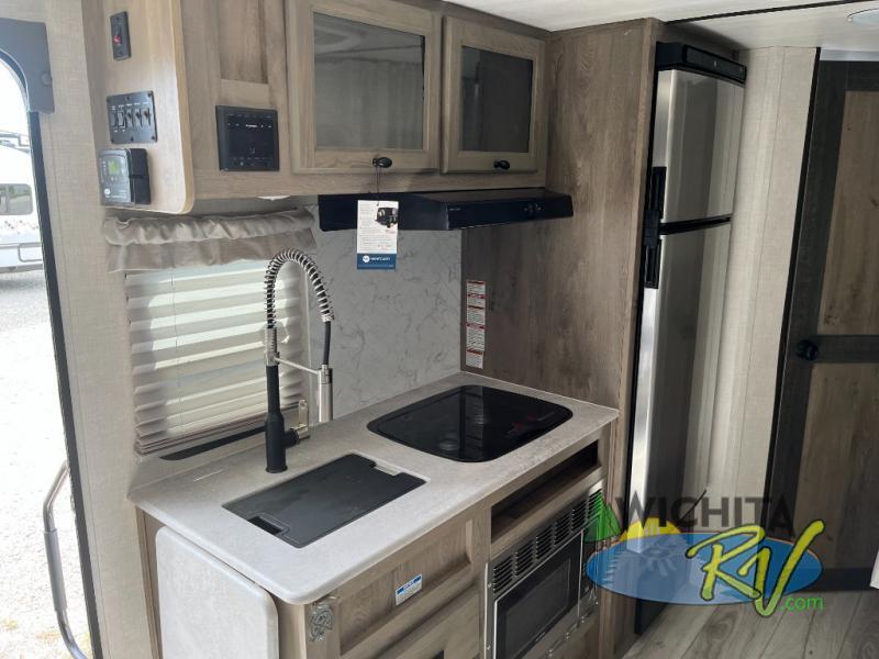 Kitchen with a gas range, fridge, oven, sink and cabinets.