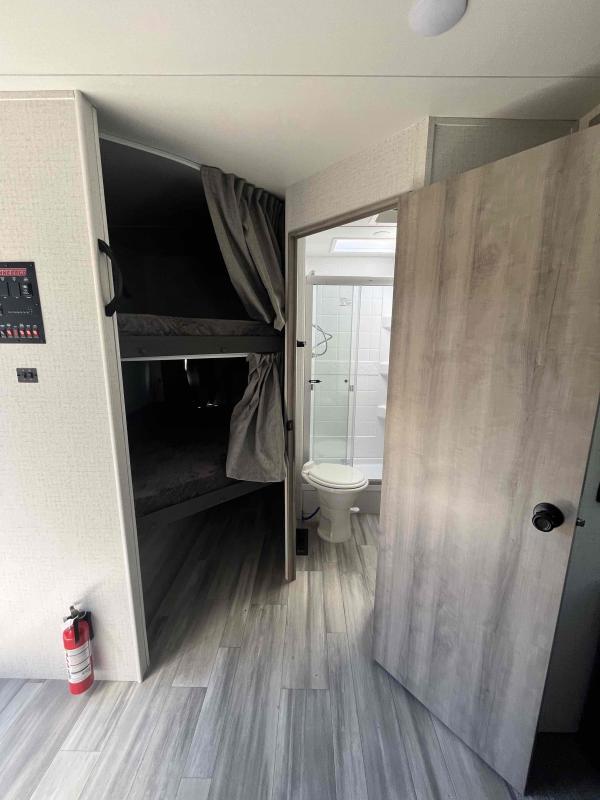 Bedroom with bunks and a bathroom.