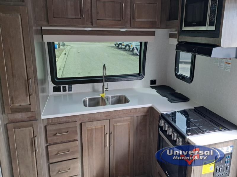 Kitchen with a gas range, oven, sink and cabinets.