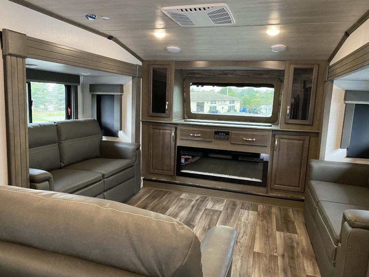 Living space with leather seats and a fireplace.