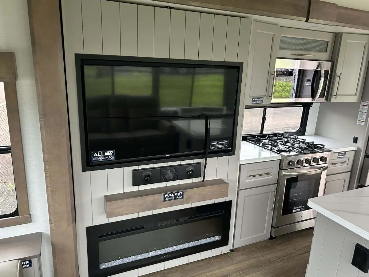 Entertainment center with a TV and a fireplace.