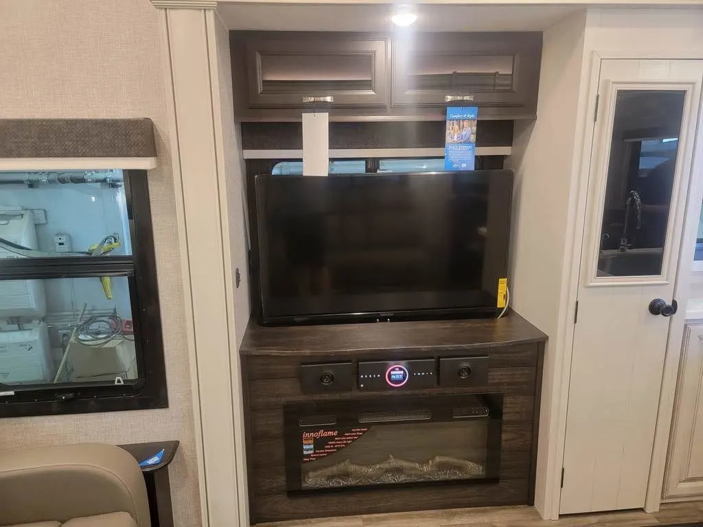 Entertainment center with a TV and a fireplace.