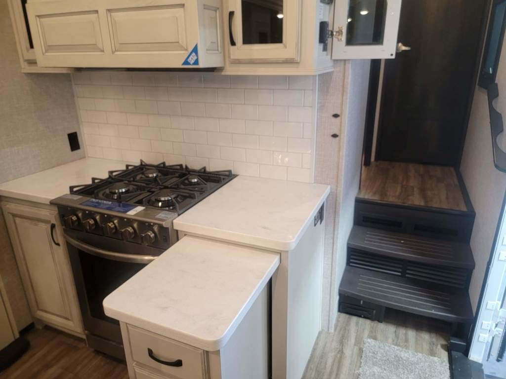 Kitchen with a gas range and cabinets.