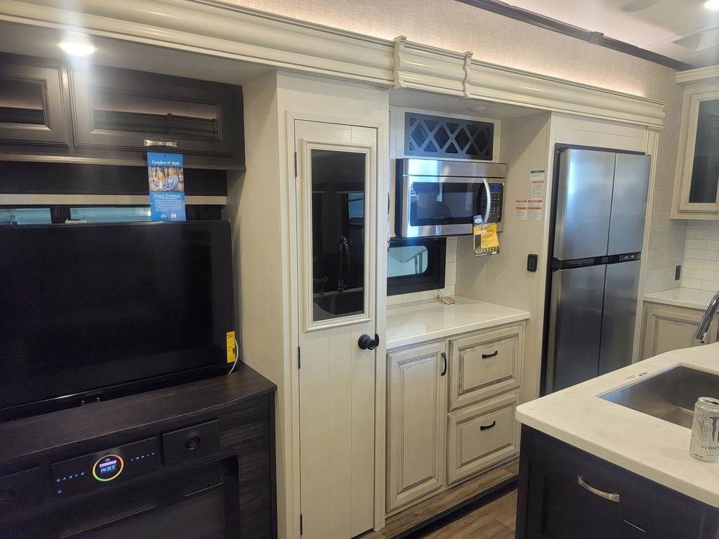 Kitchen with a gas range, fridge, oven, sink and cabinets.