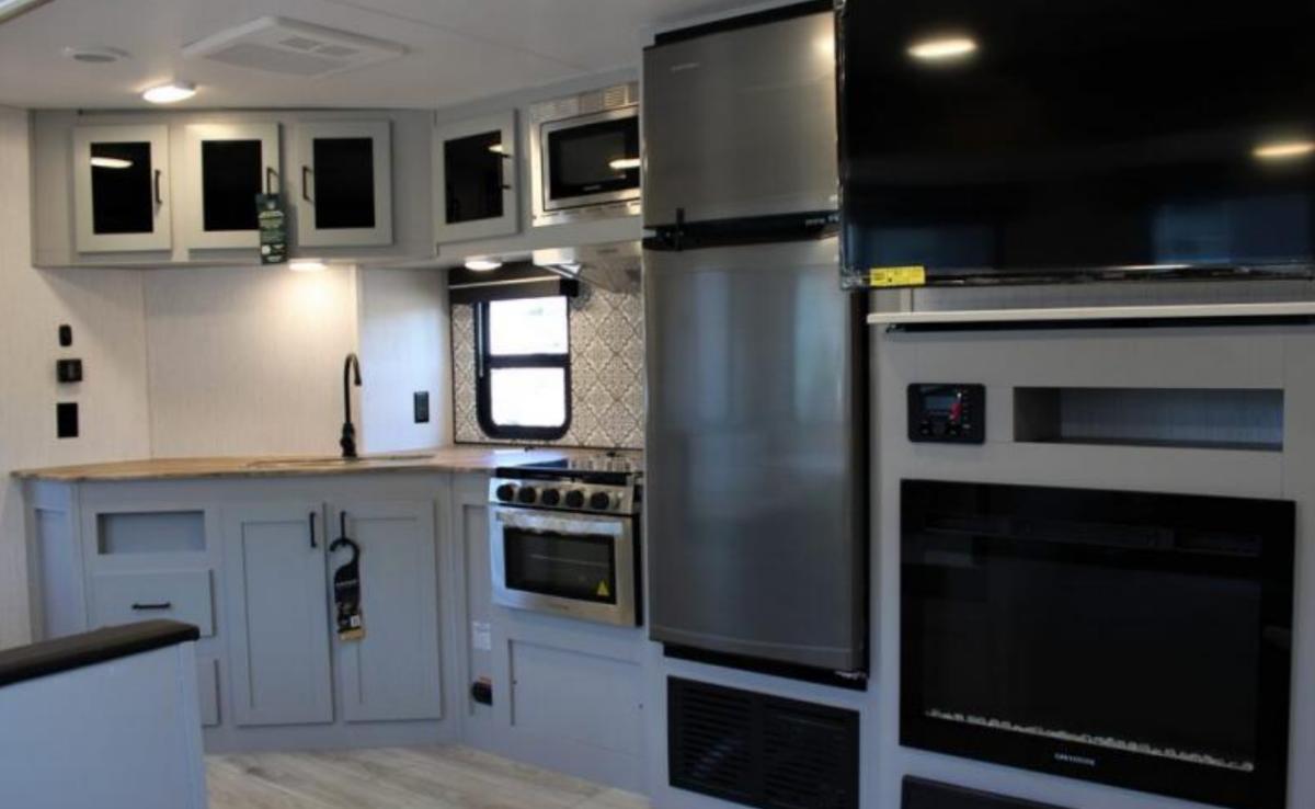 Kitchen with a gas range, fridge, oven, sink and cabinets.