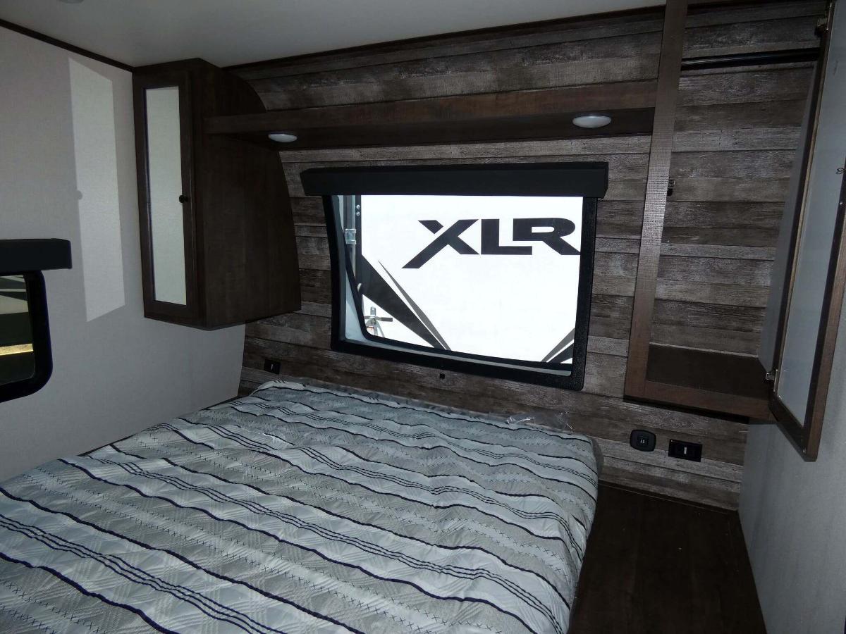 Bedroom with a queen size bed and shirt closets.