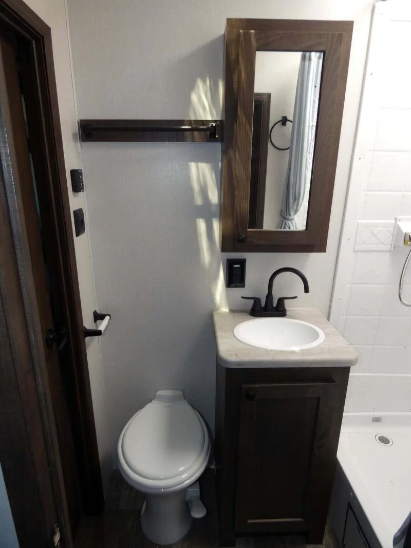 Bathroom with a sink, toilet and a shower.