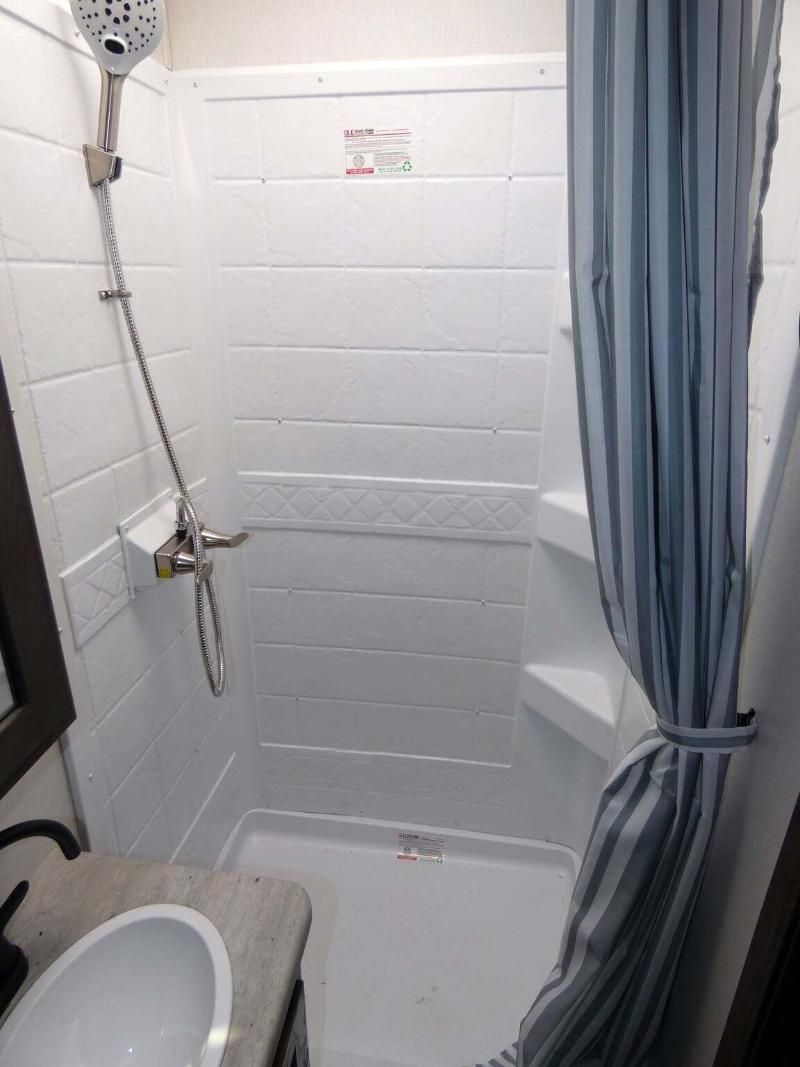 Bathroom with a sink and a shower.