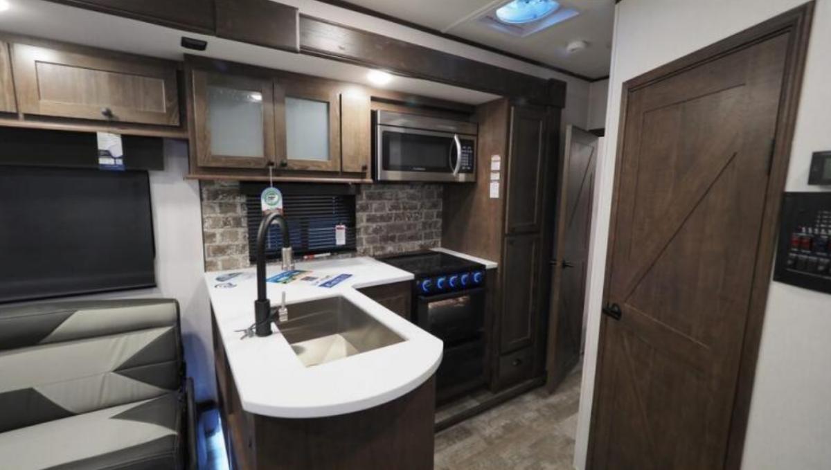 Kitchen with a gas range, oven, sink and cabinets.