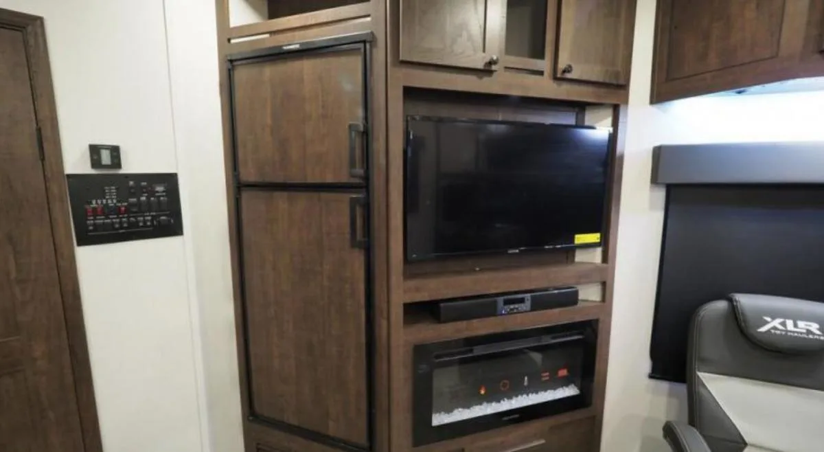 Entertainment center with a TV and a fireplace.