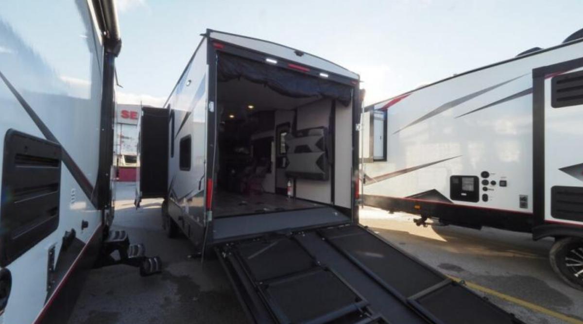 Rear view of the RV with a ramp.