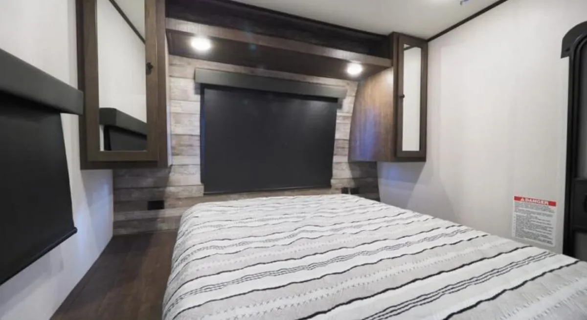 Bedroom with a queen size bed and shirt closets.