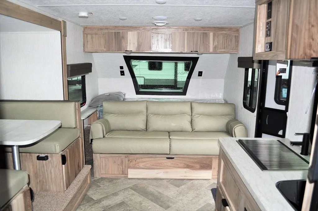 Living space with leather seats and overhead cabinets. 