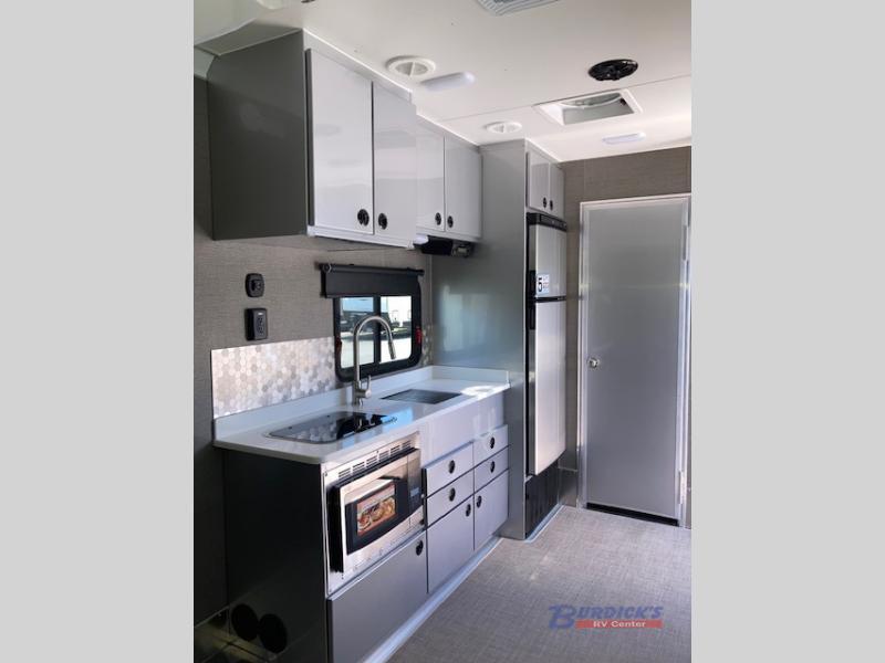 Kitchen with a gas range, fridge, sink and cabinets.