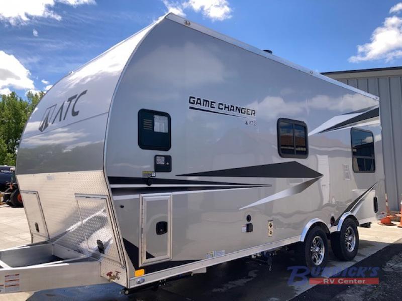 Side view of the New 2022 ATC TRAILERS Game Changer 2015 Travel Trailer Toy Hauler RV.