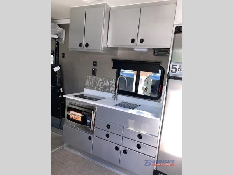 Kitchen with a gas range, fridge, sink and cabinets.