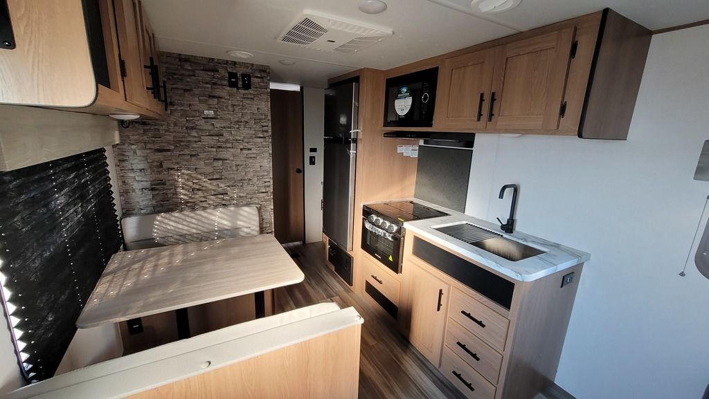 Interior view of the RV with a dinette and a kitchen.