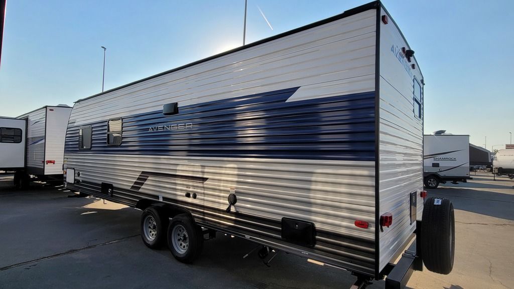 Side view of the New 2022 Prime Time Avenger 26BK Travel Trailer RV.