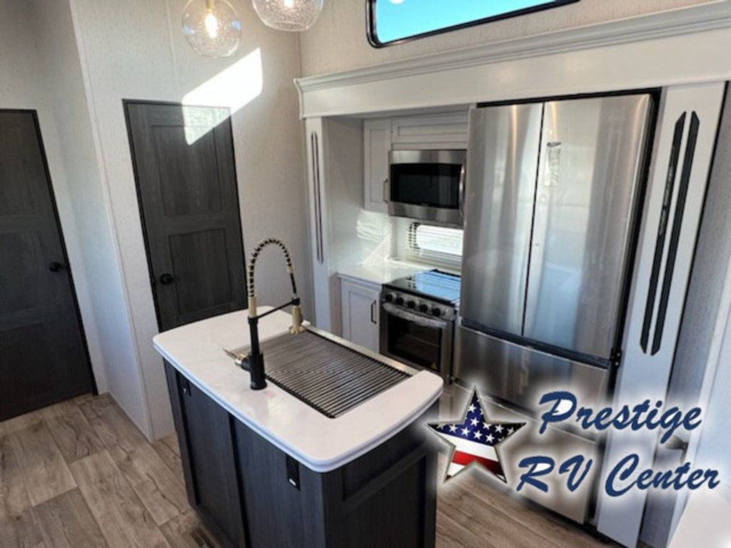 Kitchen with a gas range, fridge, oven, sink and cabinets.