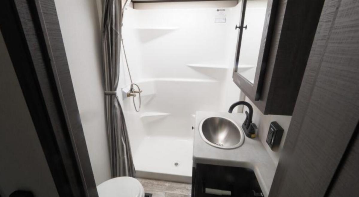 Bathroom with a sink, toilet and a walk-in shower.