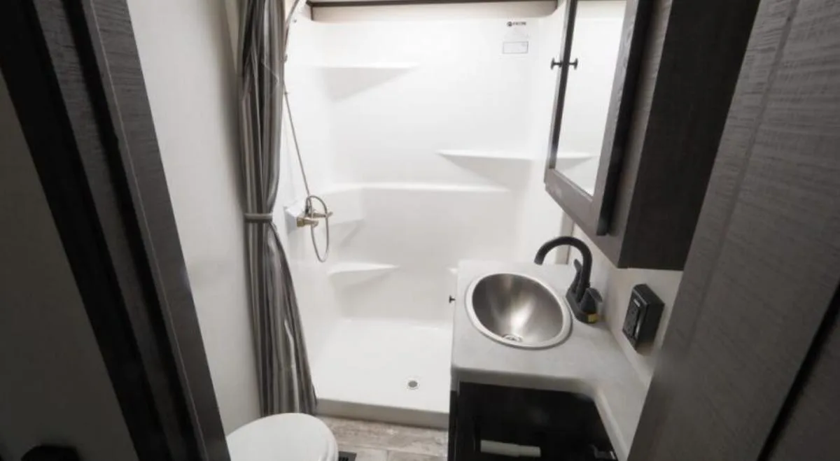 Bathroom with a sink, toilet and a walk-in shower.