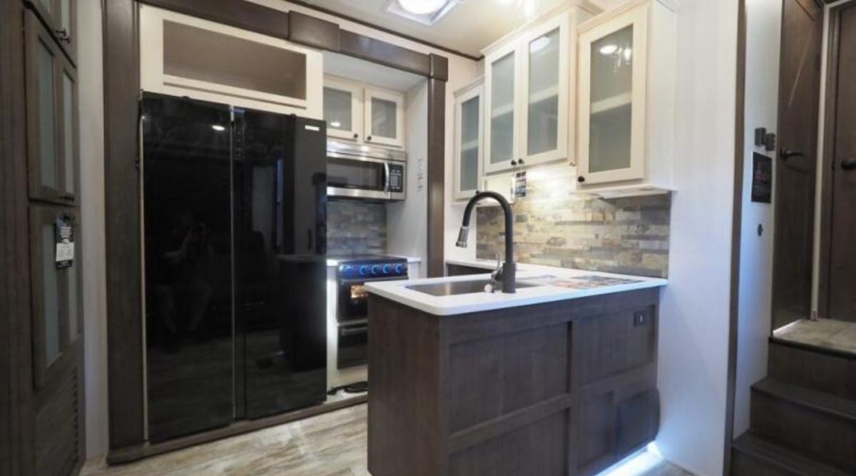 Kitchen with a gas range, fridge, oven, sink and cabinets.