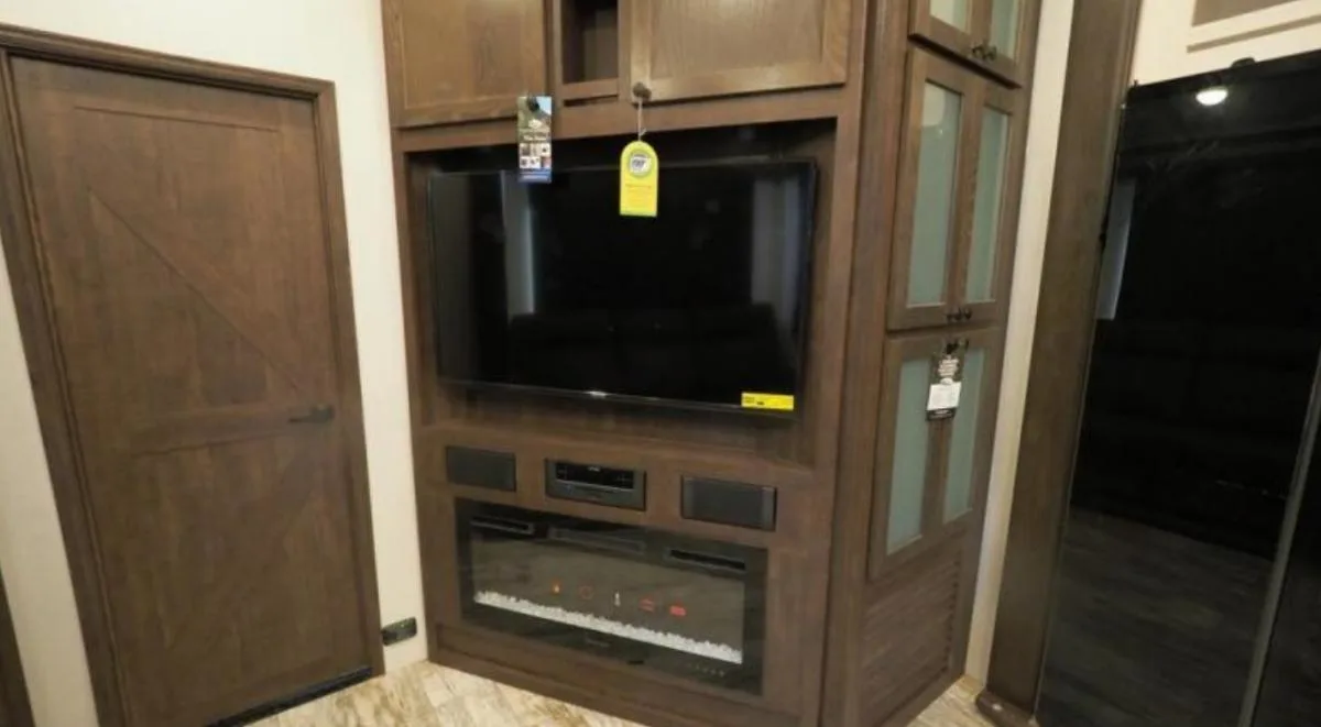 Entertainment center with a TV and a fireplace.