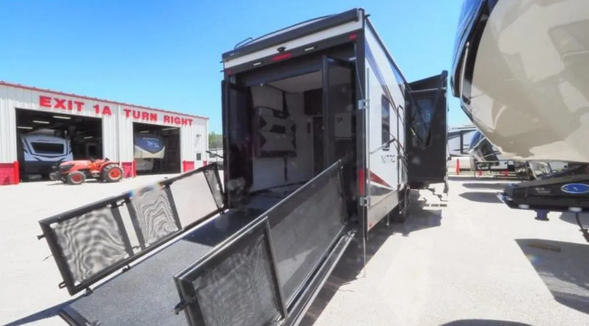 Rear view of the RV with a ramp door.