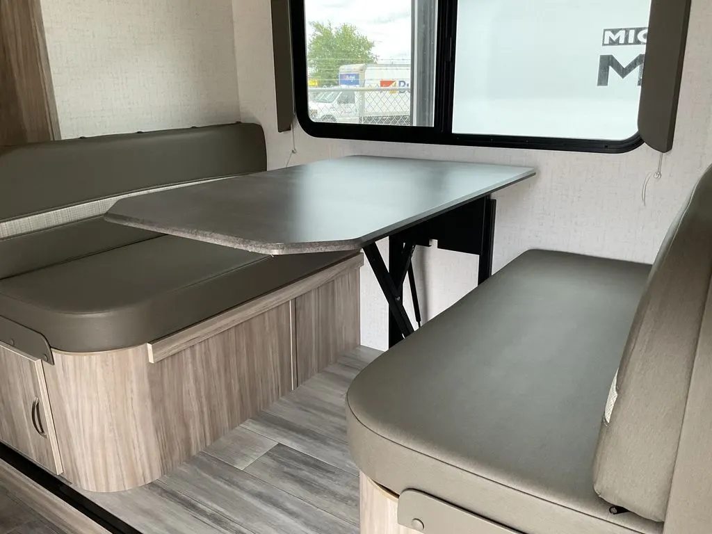 Dinette with leather seats and pull-out storage drawers.