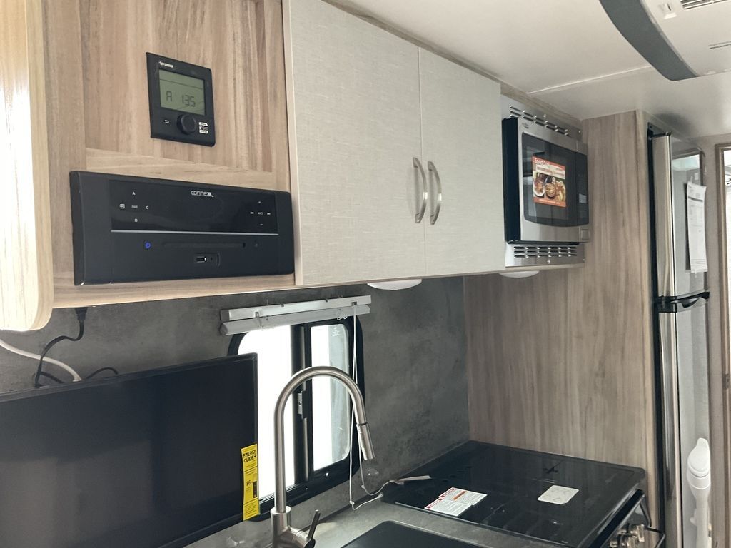 Kitchen with a gas range, oven, sink and cabinets.