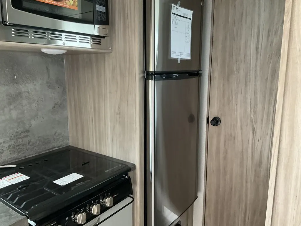 Kitchen with a gas range, fridge, and an oven.