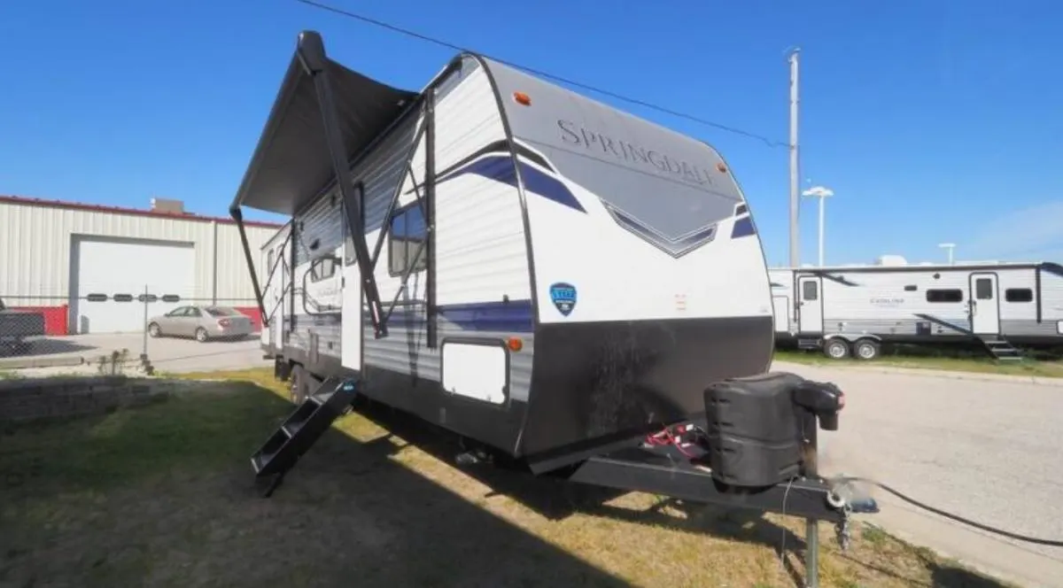 Side view of the RV with an awning.