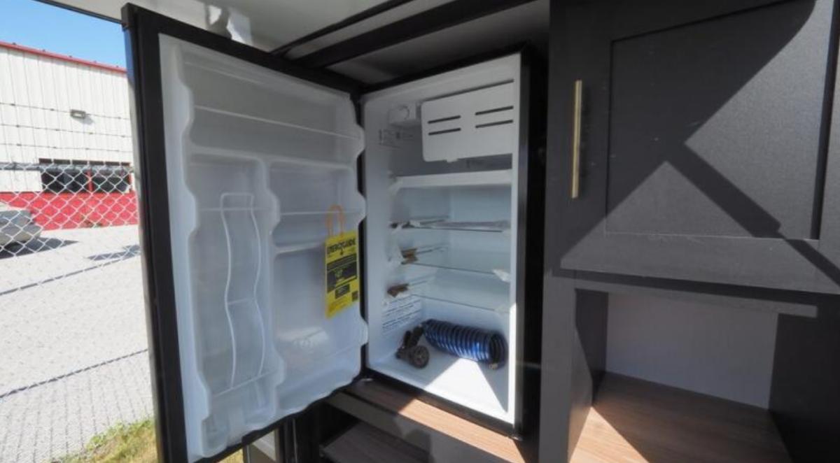 Outdoor kitchen with a fridge.