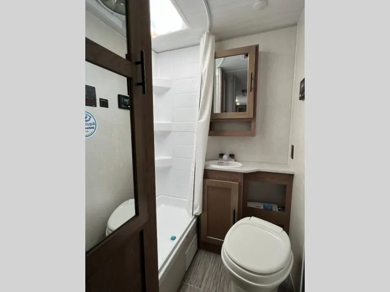 Bathroom with a sink, toilet and a walk-in shower.