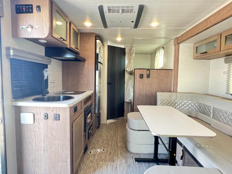 Interior view of the RV with a dinette and a kitchen.