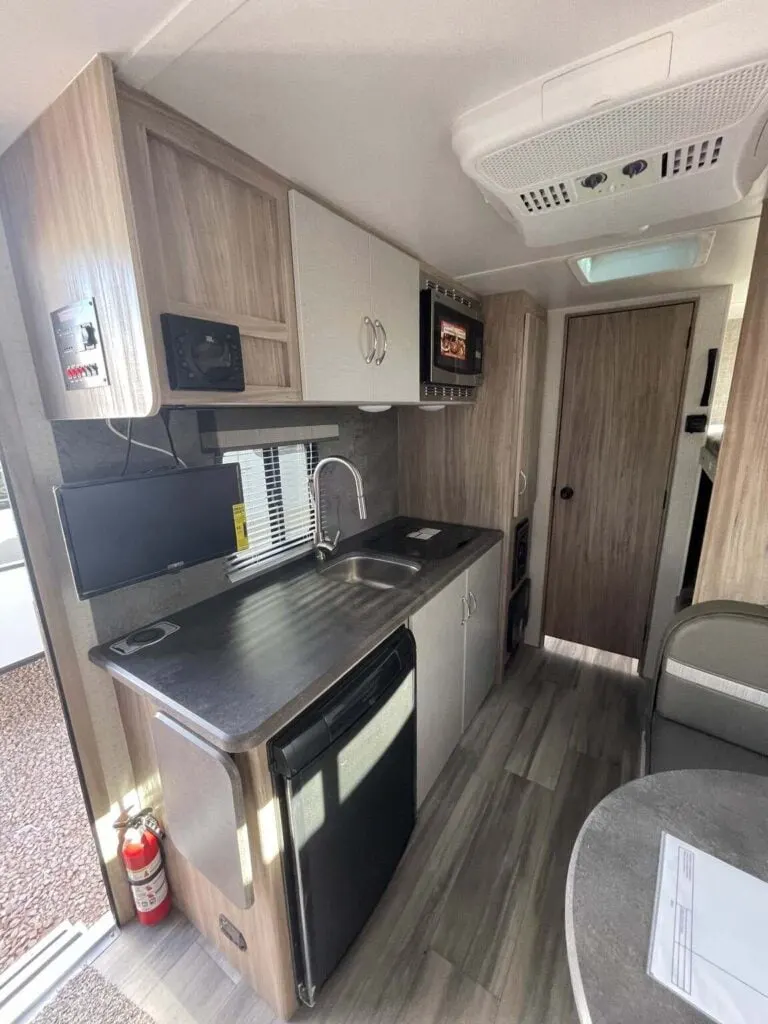 Kitchen with a gas range, oven, sink and cabinets.