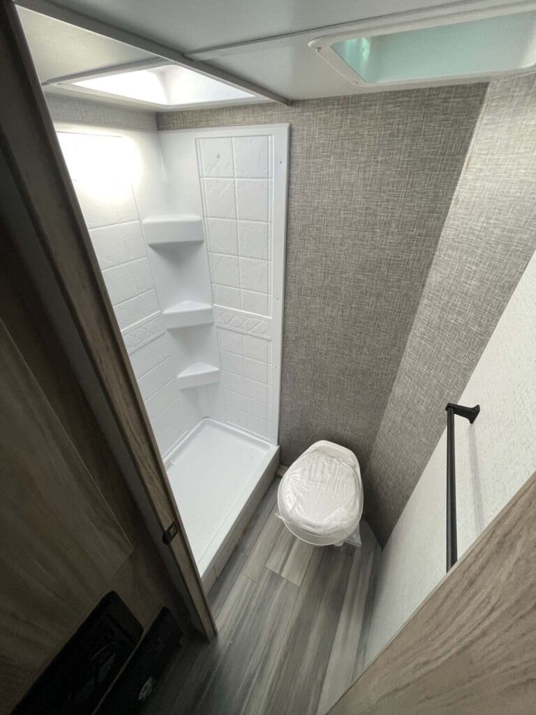 Bathroom with a toilet and a walk-in shower.