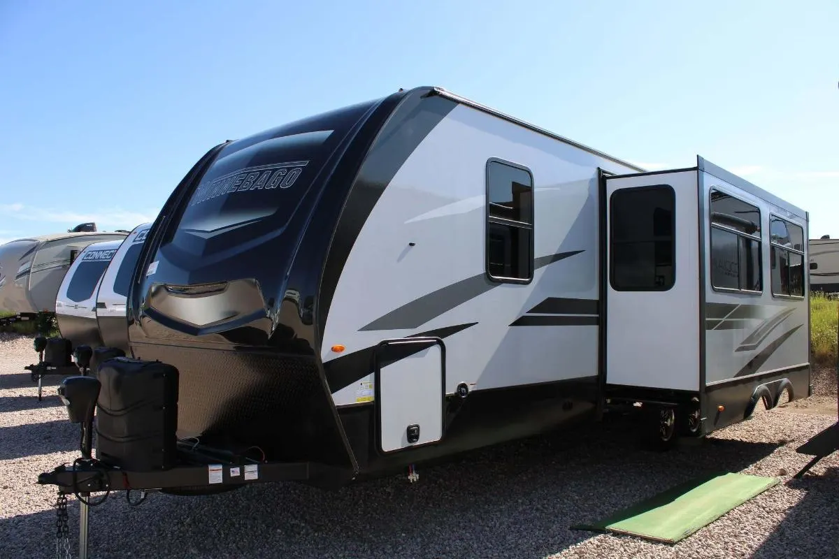 Side view of the New 2022 Winnebago Voyage V3033BH Travel Trailer RV.