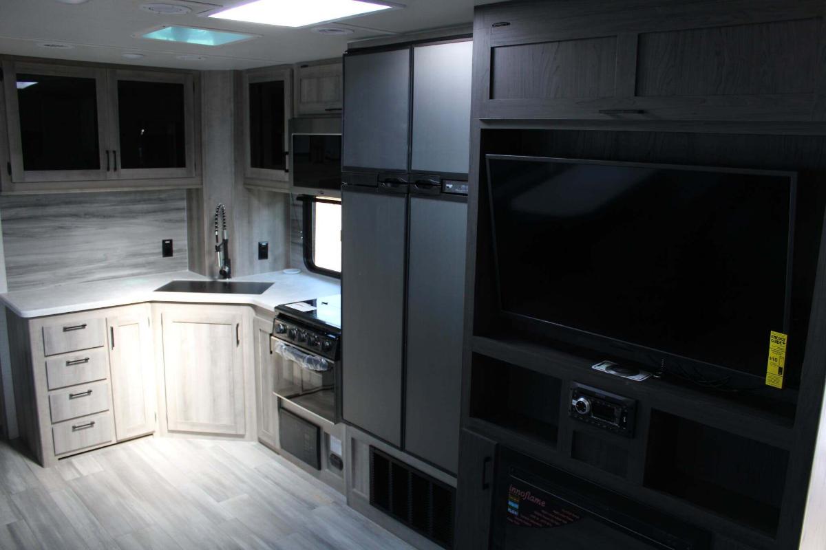 Kitchen flanked by the entertainment center.