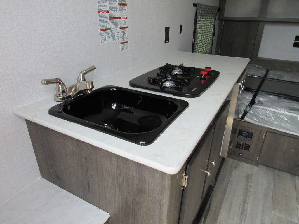 Kitchen with a gas range, sink and cabinets.