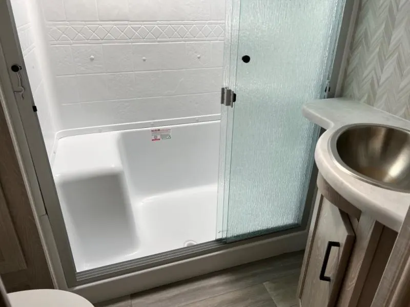 Bathroom with a sink and a walk-in shower.