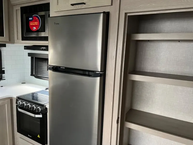 Kitchen with a gas range, fridge, oven, and cabinets.