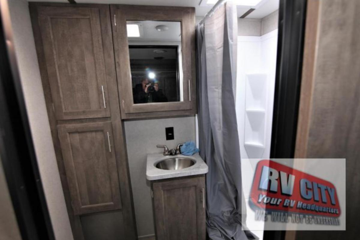 Bathroom with a sink, medicine cabinet and a walk-in shower.