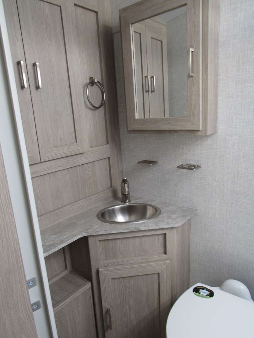 Bathroom with a sink, toilet and a medicine cabinet.