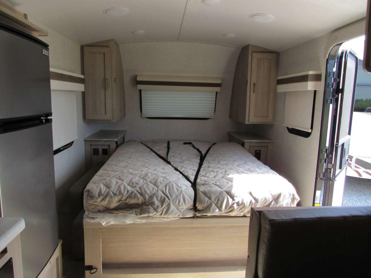 Bedroom with a queen size bed and shirt closets.