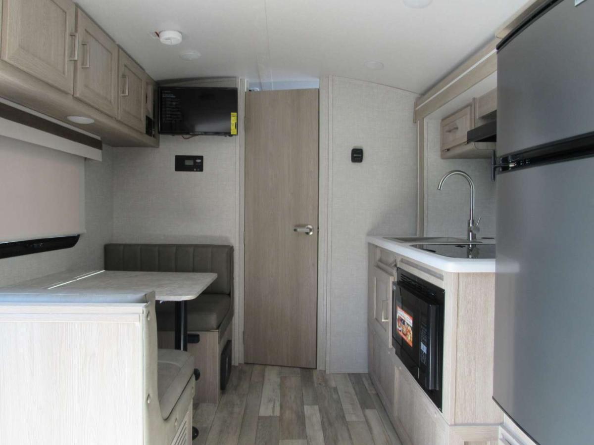 Interior view of the RV with a dinette and a kitchen.