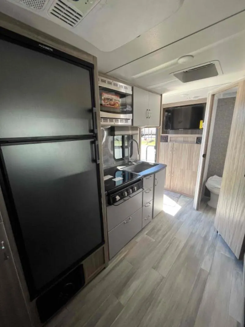 Kitchen with a gas range, fridge, oven, sink and cabinets.