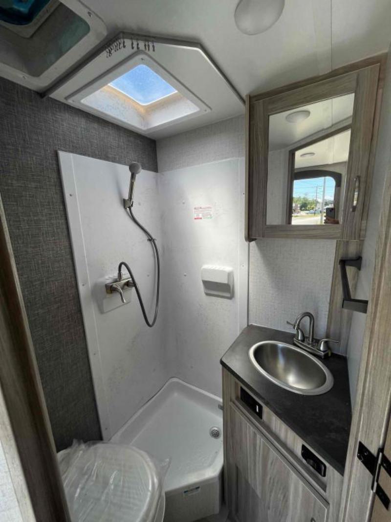 Bathroom with a sink, toilet and a walk-in shower.