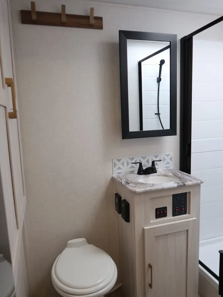 Bathroom with a sink, toilet and a walk-in shower.