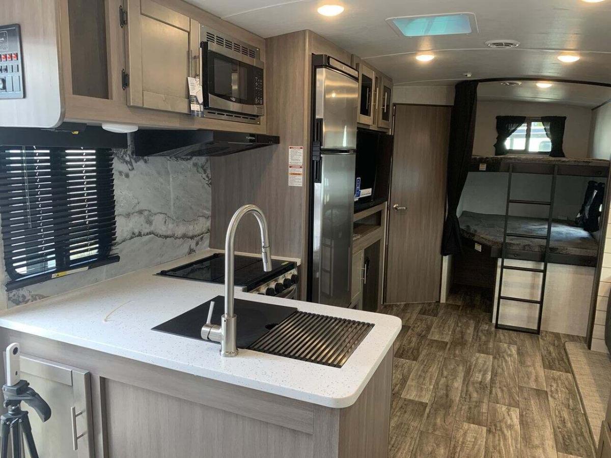 Interior view of the RV with a bedroom and a kitchen.